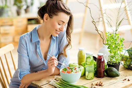 The girl eats a salad